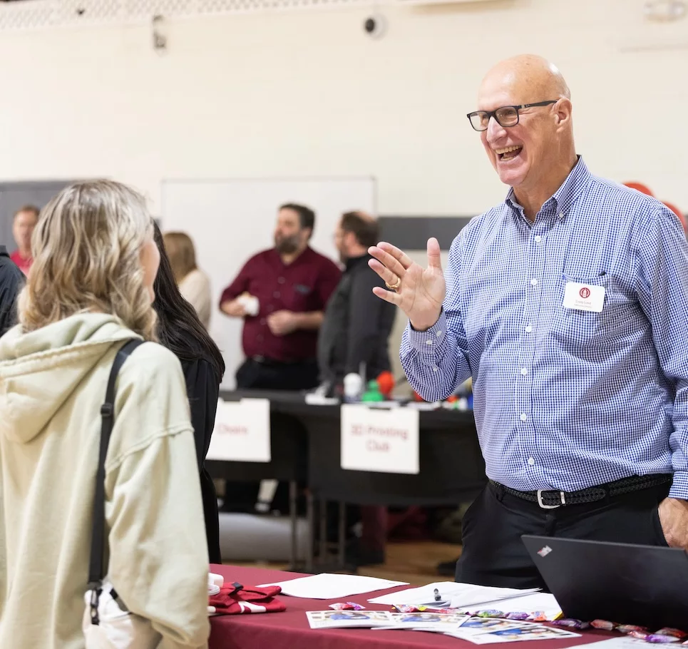 Admissions counselor speaking with a student.