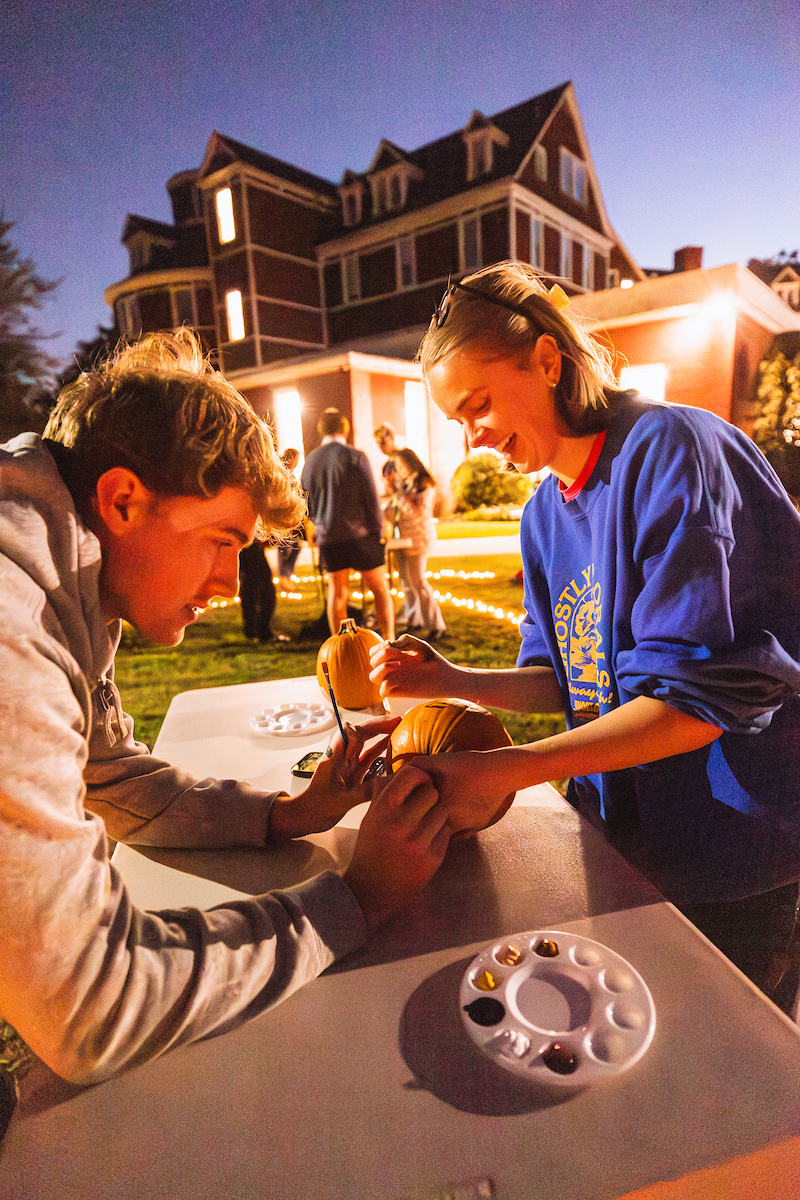 Students painting a pumpkin