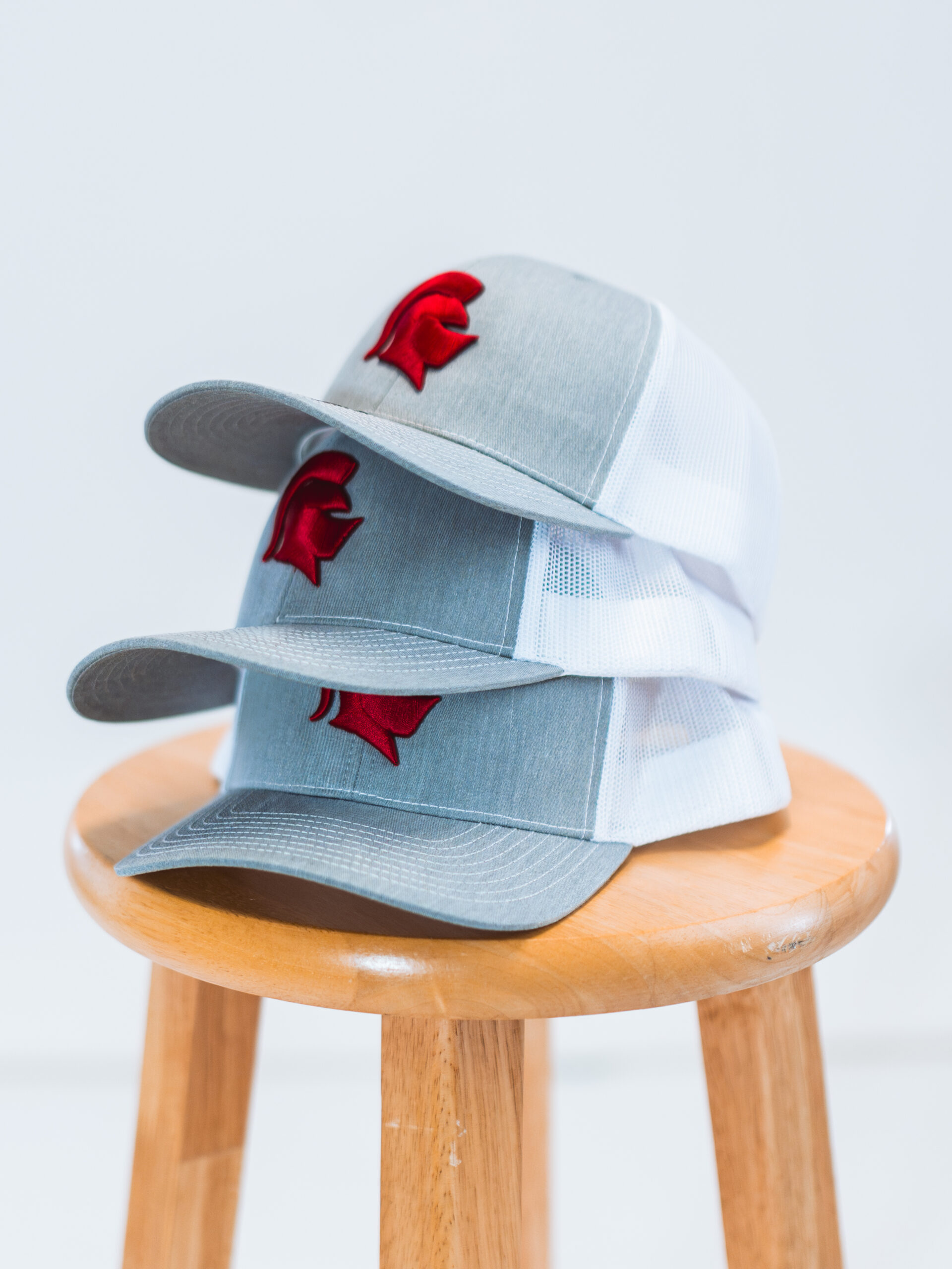 3 hats stacked on a chair