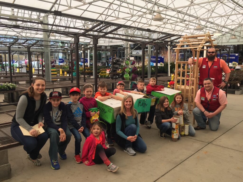 A class of children with teachers in a greenhouse