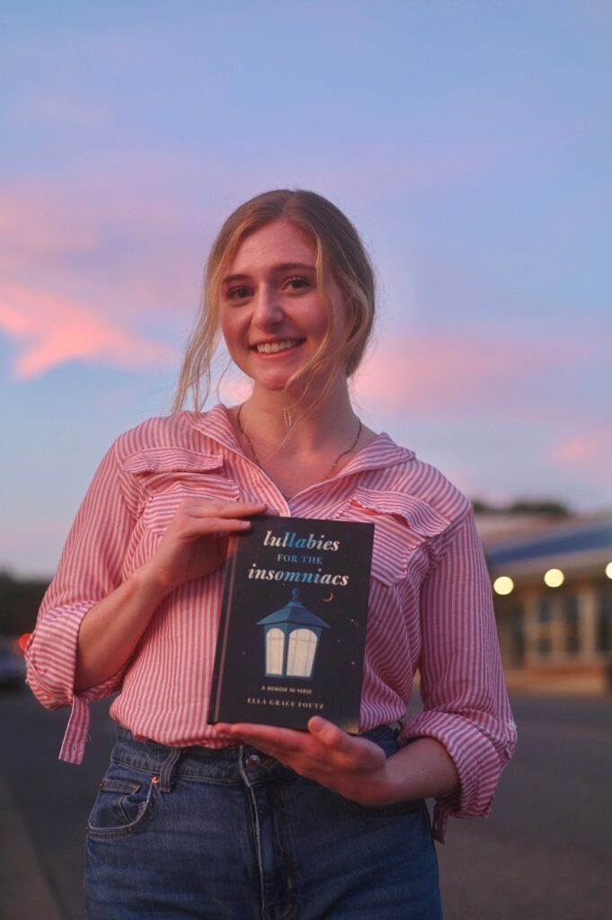 A woman holds a book